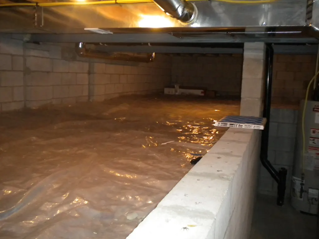 Crawl space with plastic vapor barrier and support piers