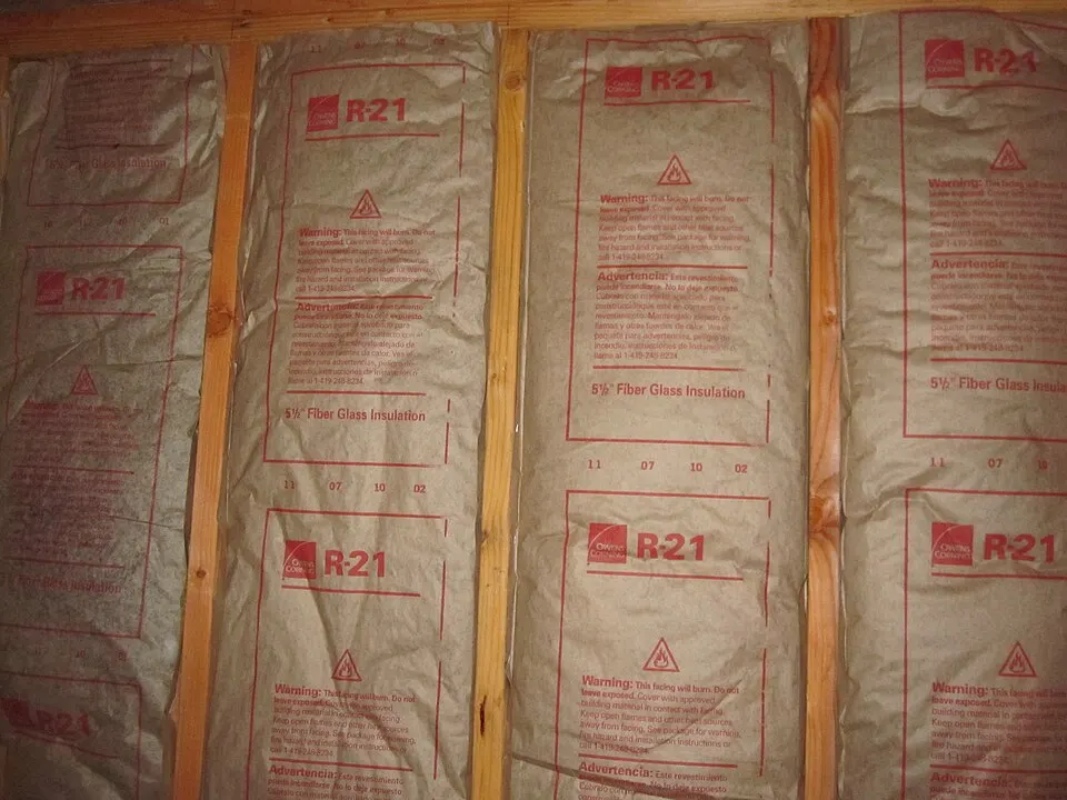 Kraft-faced fiberglass insulation batts fitted between wood framing